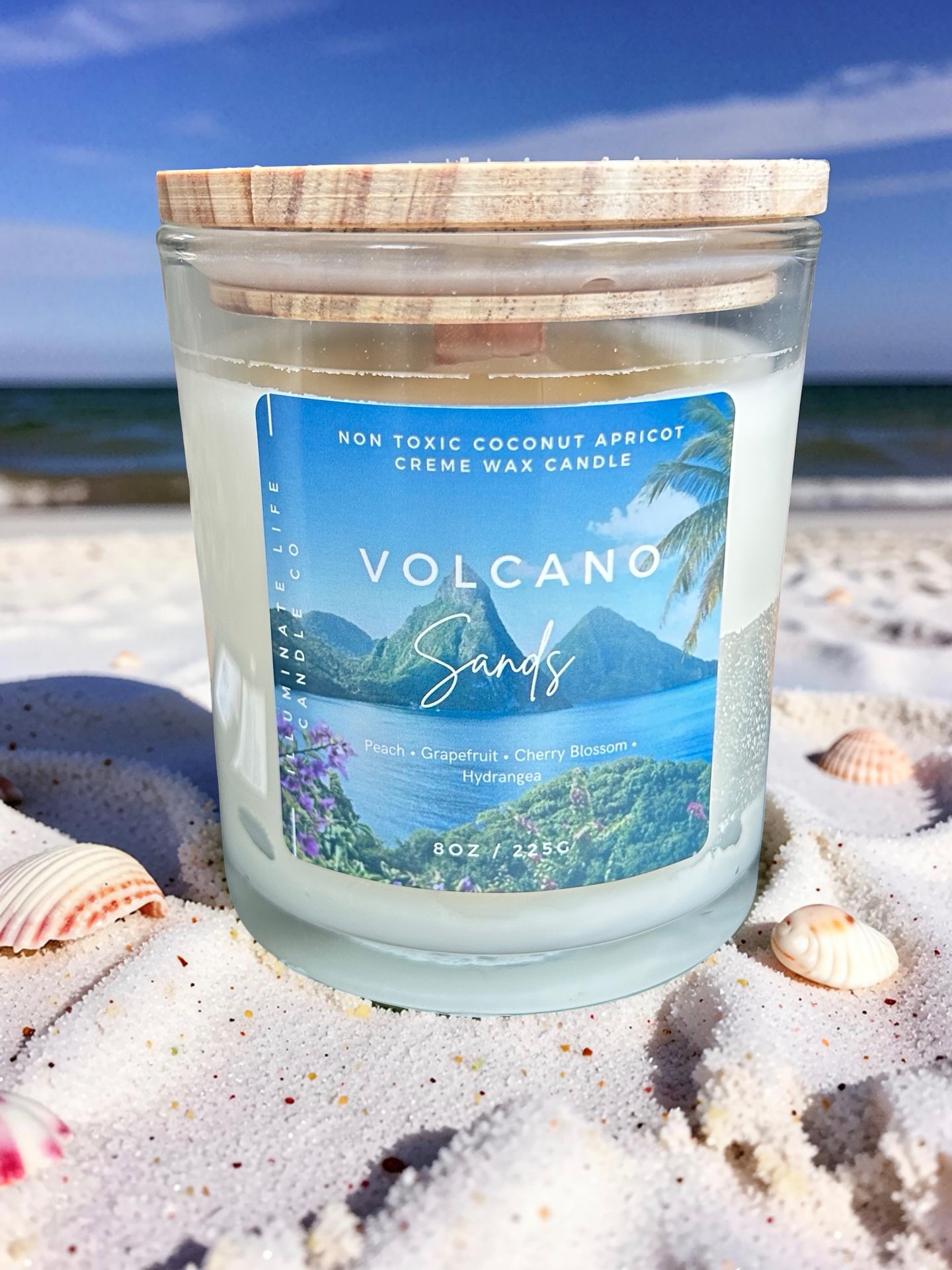 Illuminate Life Volcano Sands candle displayed on a beach